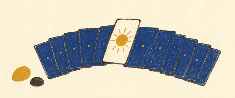 A free tarot reading: a deck fanned in a wide arc with one card lifted face up to show the sun, two tumbled stones beside it